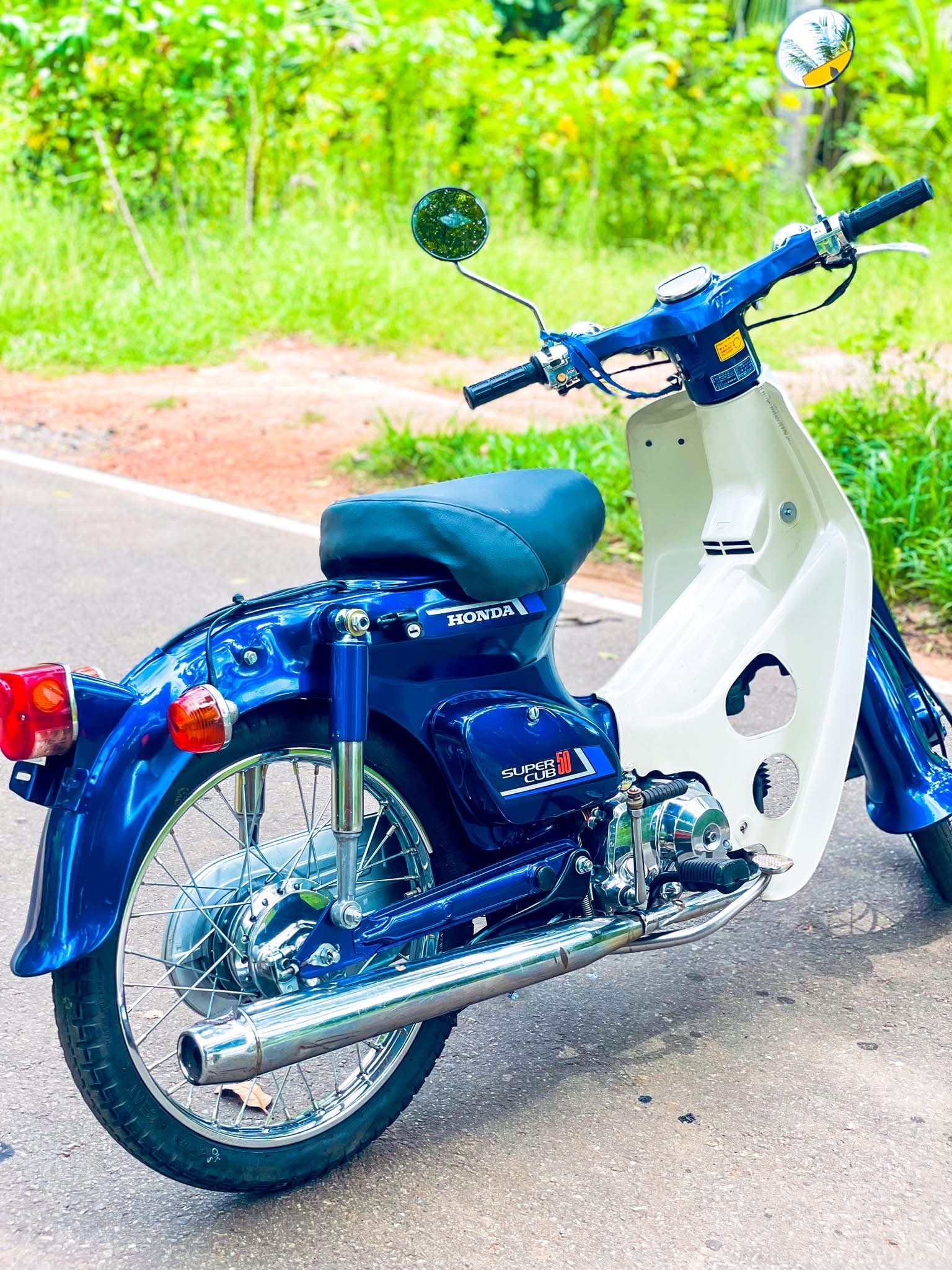 Rear view of restored blue Honda Super Cub