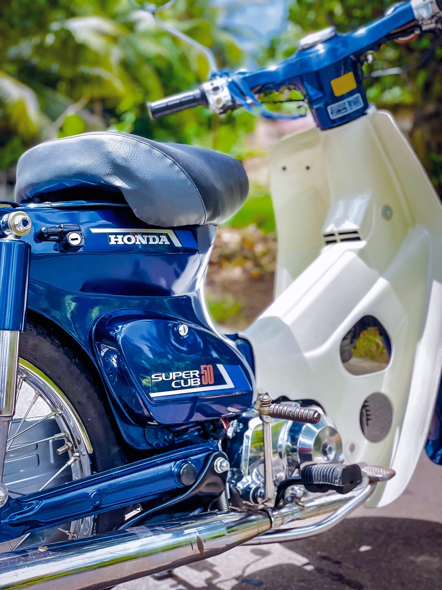 Close view of a restored blue Honda Super Cub