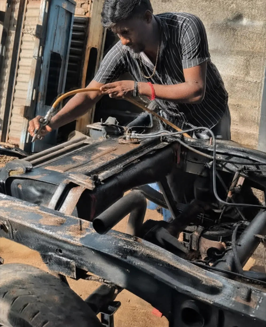 Vintage Garage craftsman preparing a vehicle chassis