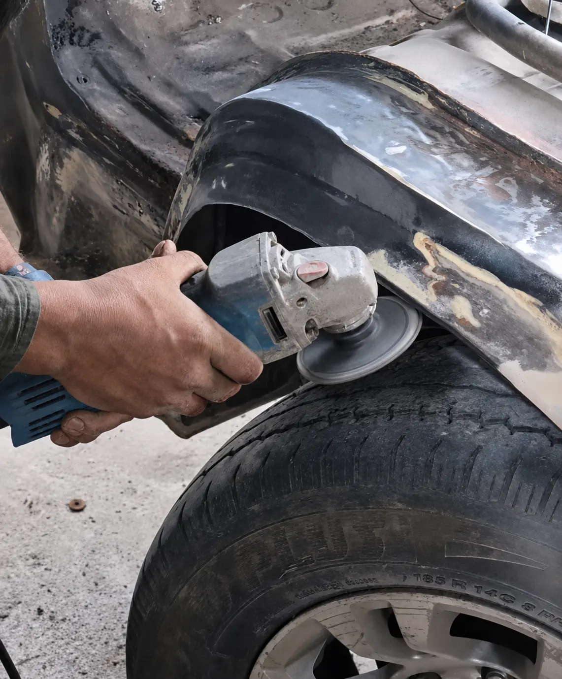 Worker correcting a vehicle body surface